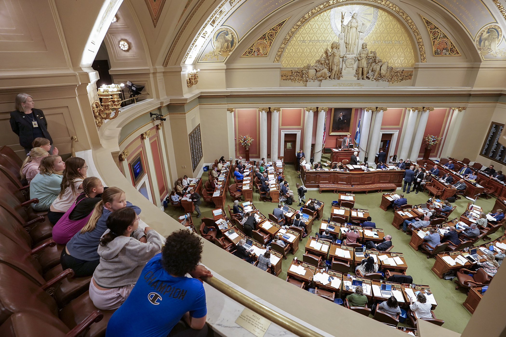 Fourth-grade students from St. Katharine Drexel School in St. Cloud are literally on the edge of their seats Thursday during a Capitol tour featuring a live floor session. (Photo by Michele Jokinen)